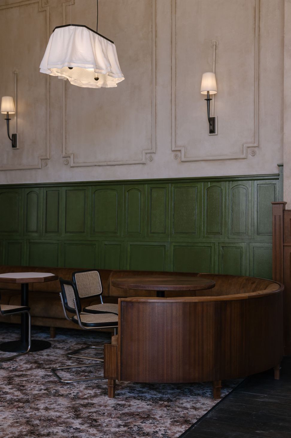 A booth against green timber panelling