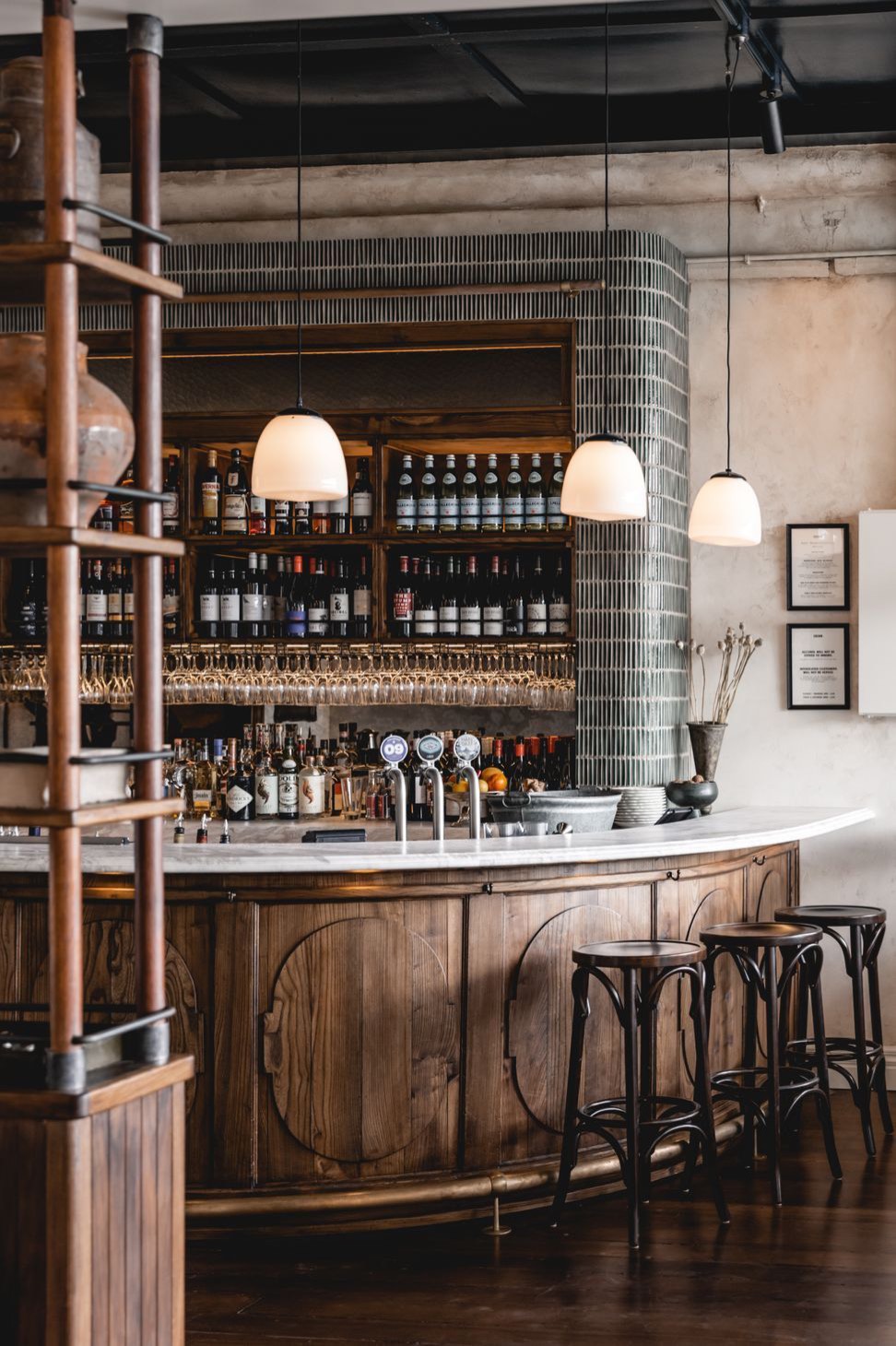 The curved timber bar and tiled column