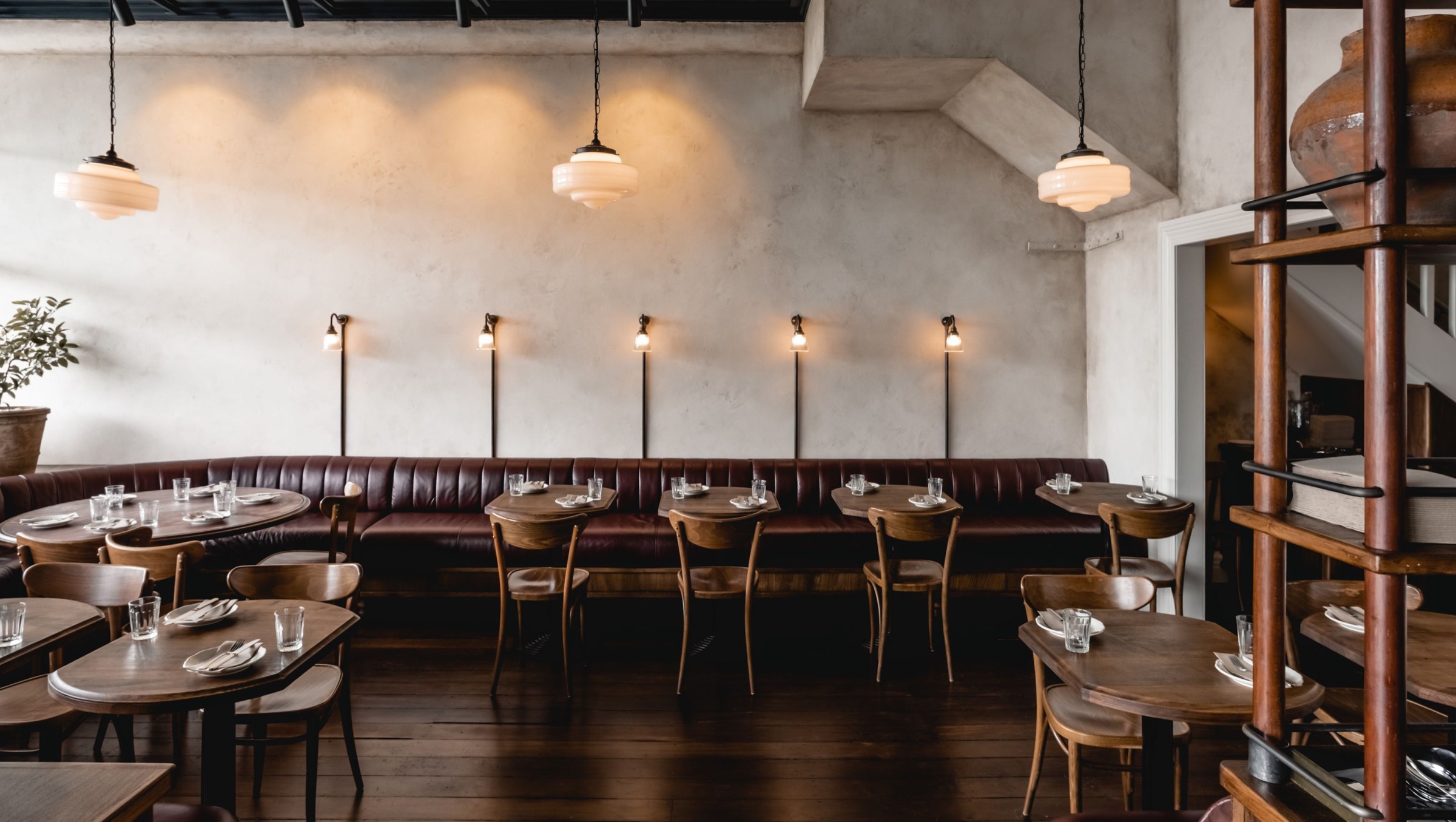 Lilian's dining room, with a long leather banquette and wall lights