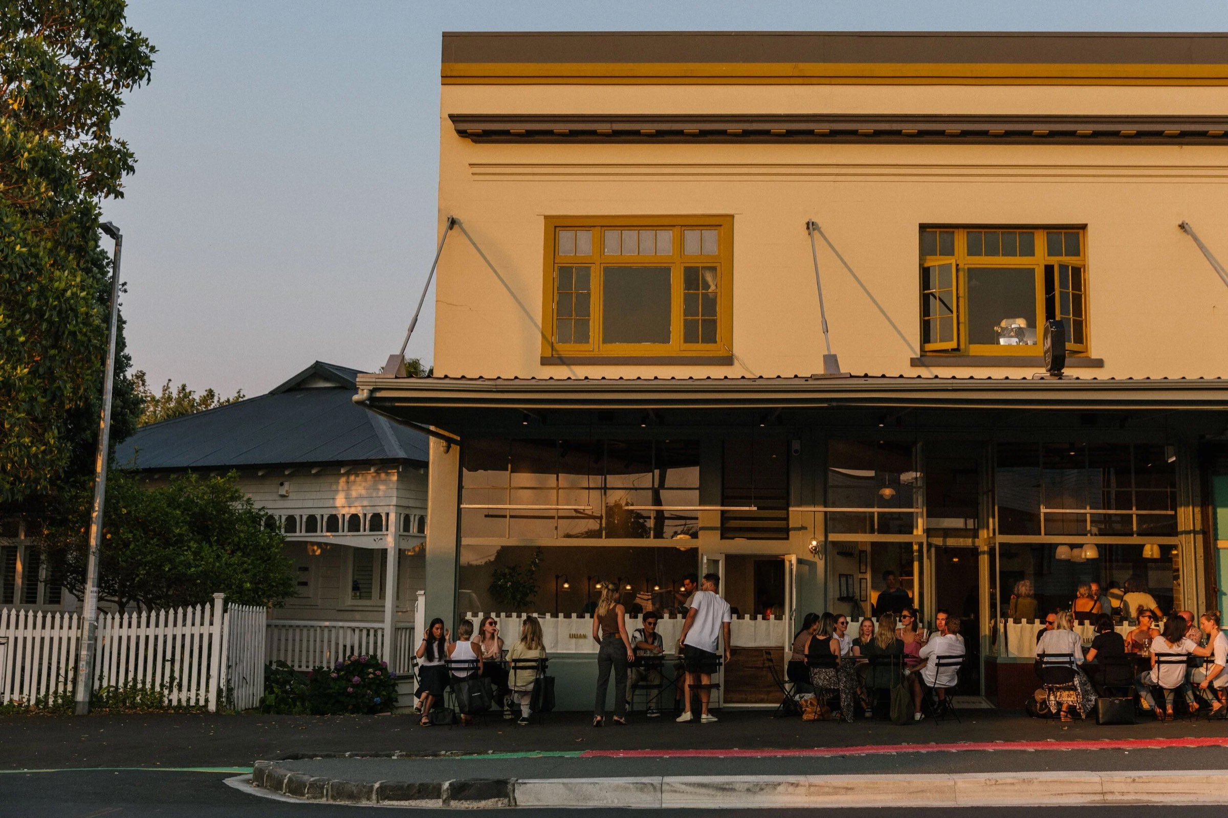 Lilian's Richmond Road frontage at dusk, with guests at tables outside