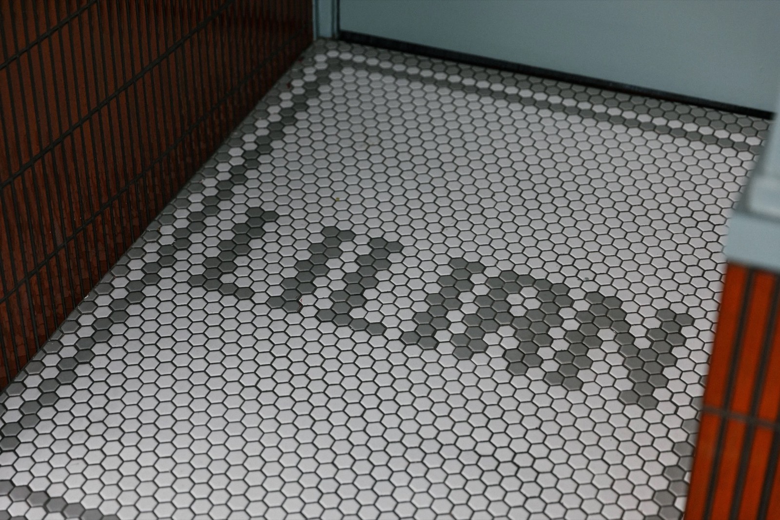 The Lilian name set into the mosaic tile floor at the entrance