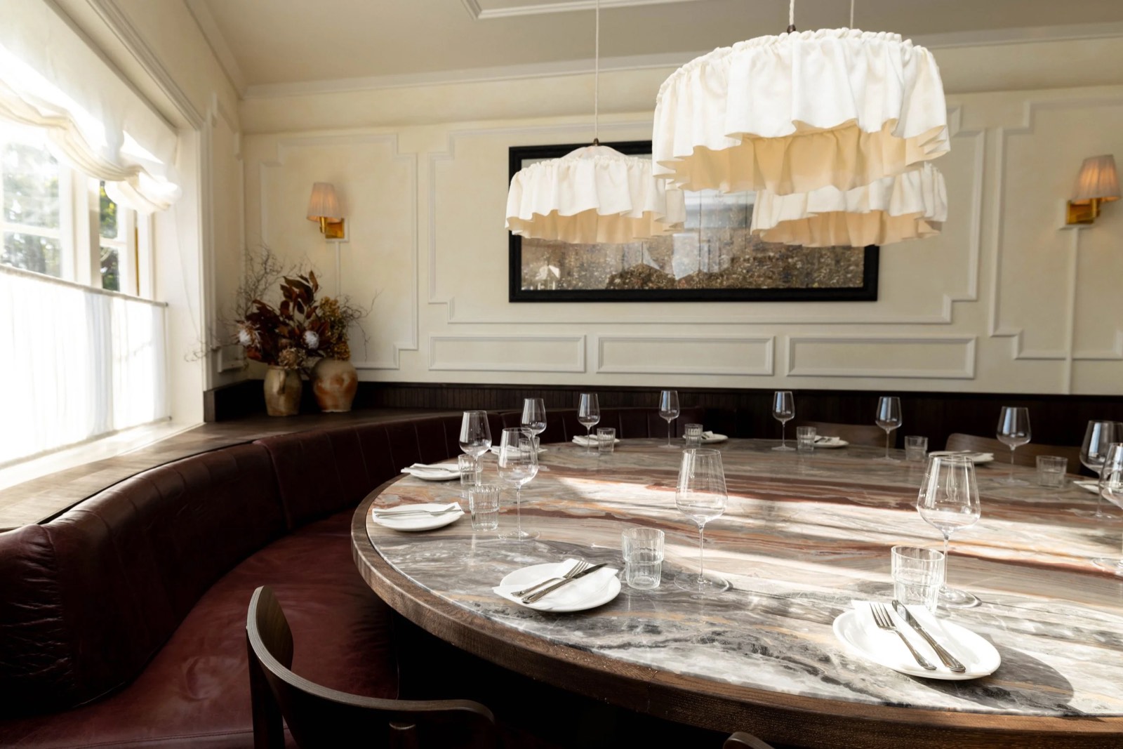 The private dining room, with a long marble table and ruffled pendant lights