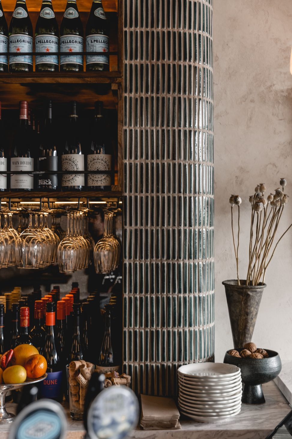 Wine shelves beside the tiled column