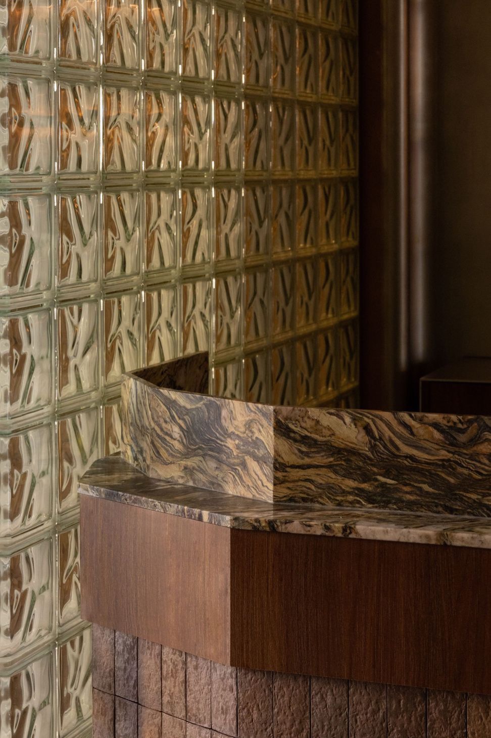 Glass brick wall and faceted stone counter